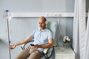 minimal-adult-man-with-headphones-during-iv-drip