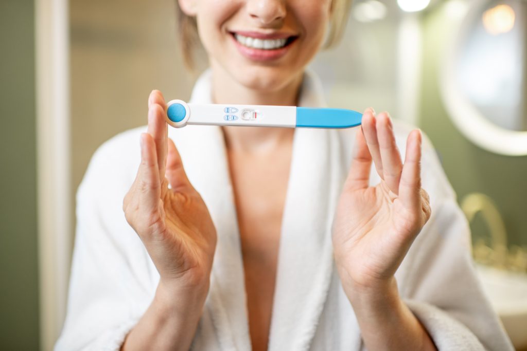 female-holding-pregnancy-test-stick