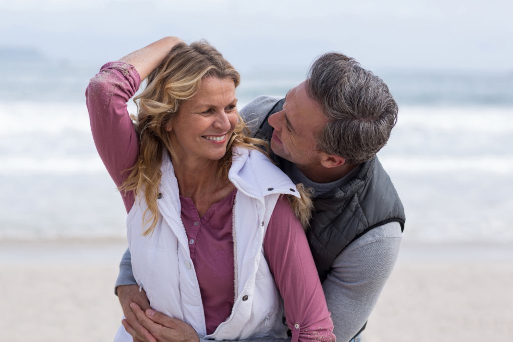 mature-couple-enjoying-on-the-beach