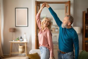 happy-senior-couple-dancing-having-fun-at-home