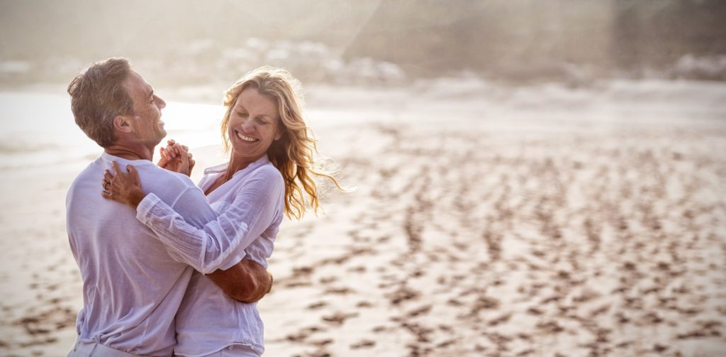 mature-couple-having-fun-together-at-beach