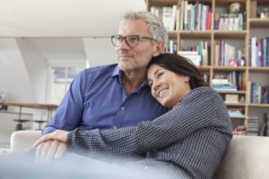 smiling-mature-couple-cuddling-at-home