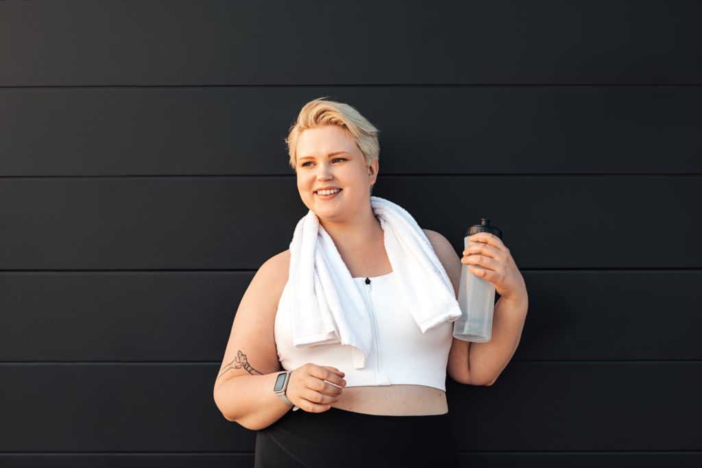 healthy-woman-relaxing-after-training-holding-a-bottle