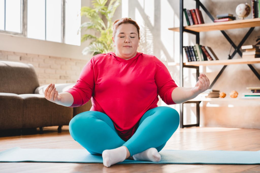 plump-obese-caucasian-fat-woman-meditating-in