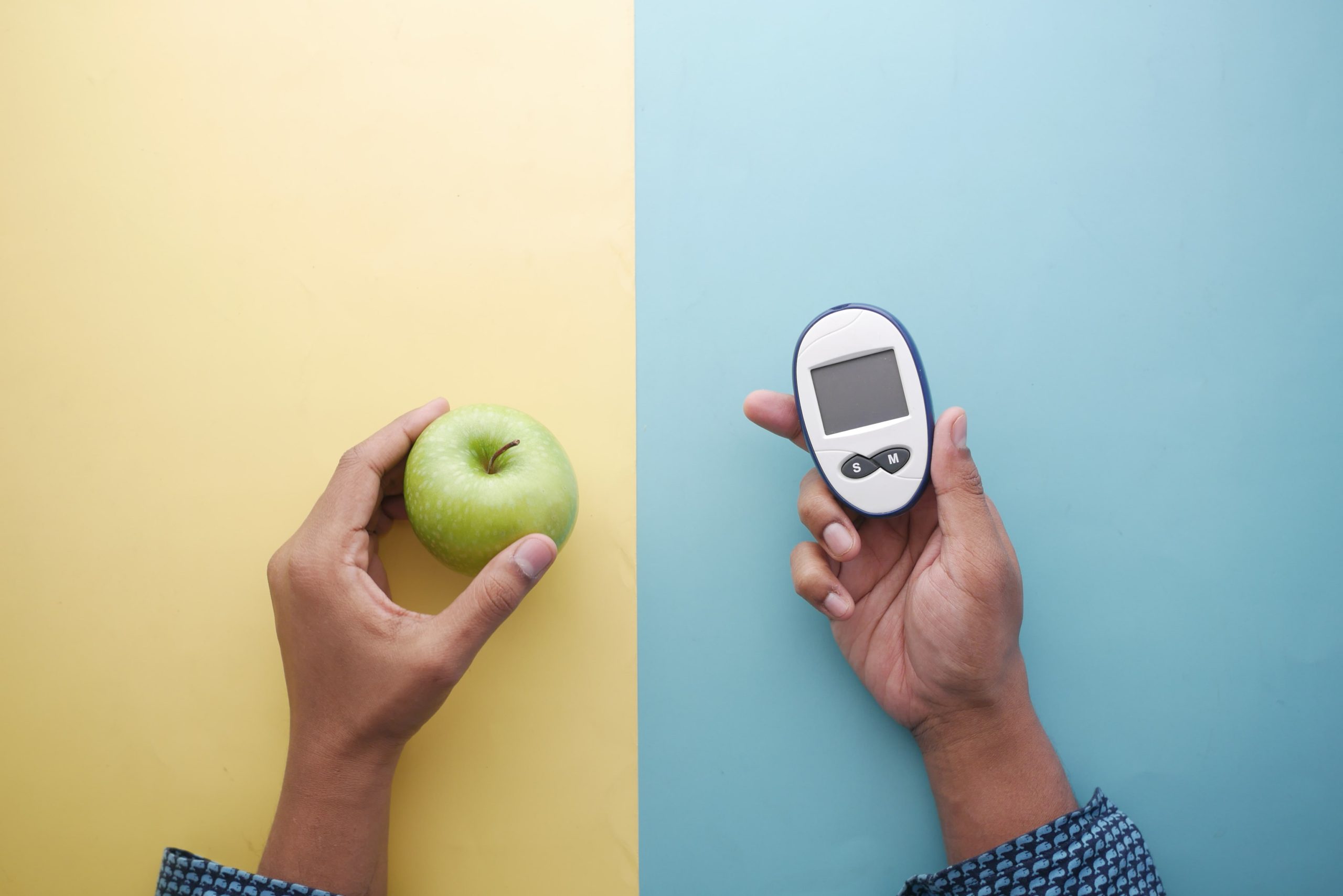 holding-diabetic-measurement-tools-apple-on-table