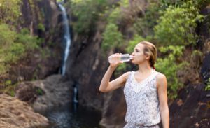 young-healthy-woman-drinks-water-from-bottle