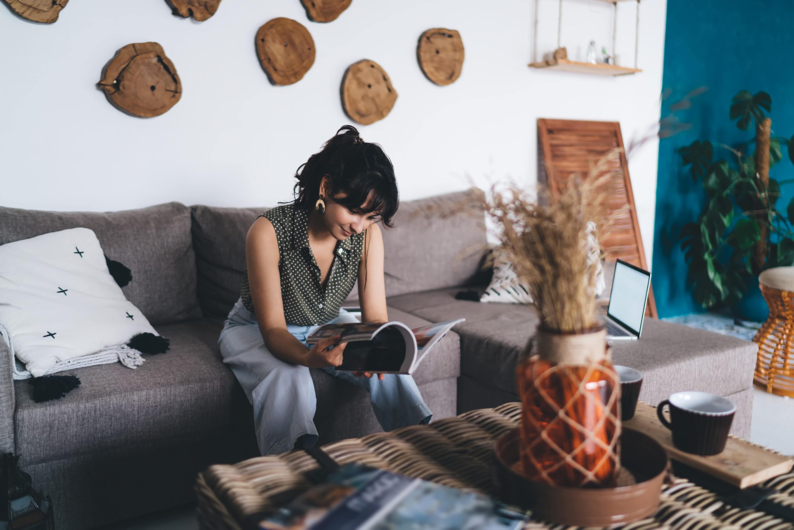 happy-female-reading-journal-in-lounge-room