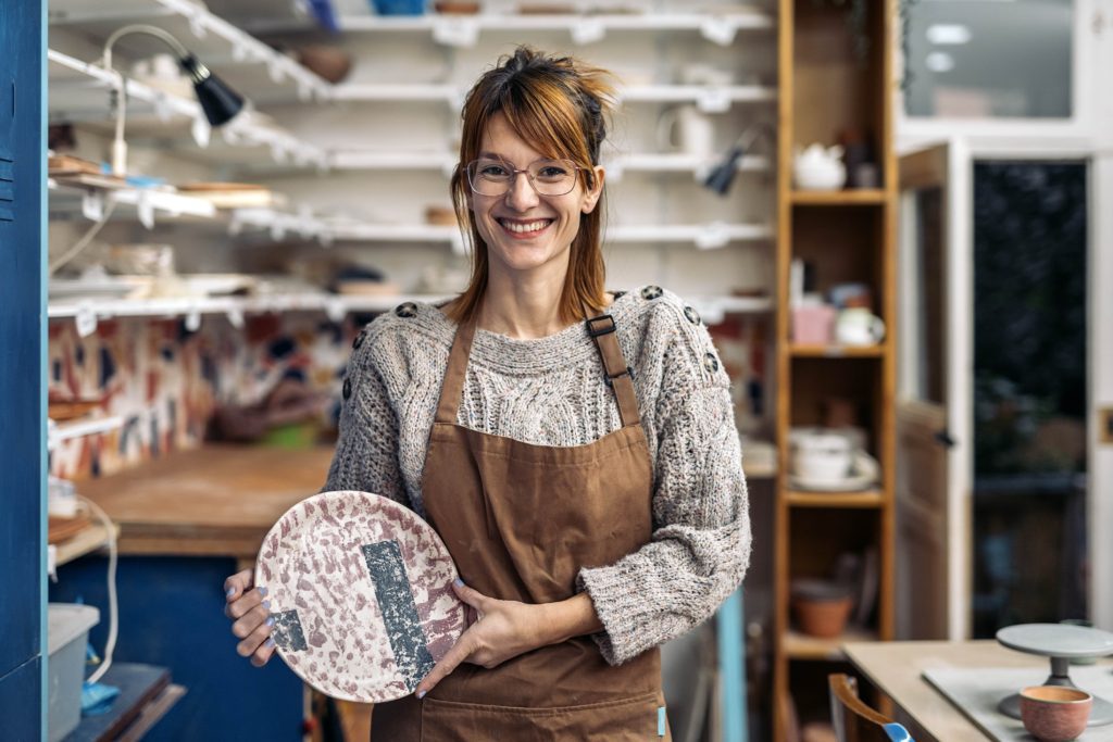 happy-woman-in-pottery-class-portrait