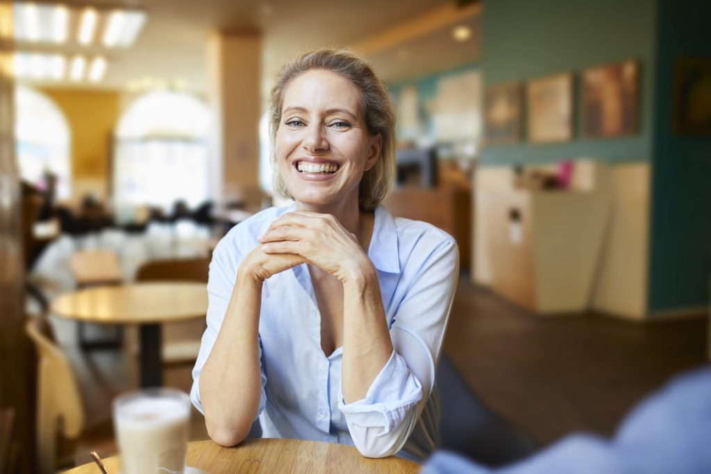 portrait-of-happy-woman-in-a-cafe