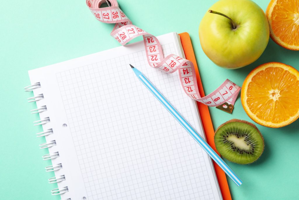 notebook-measuring-tape-pen-and-vegetarian-food