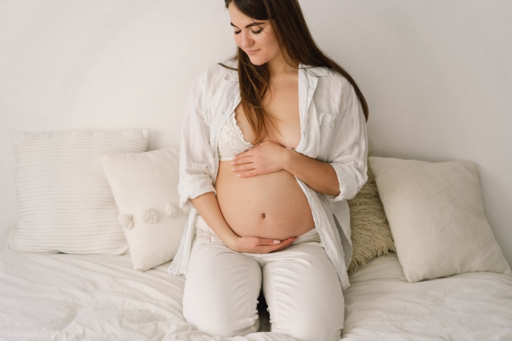 a-beautiful-pregnant-woman-dressed-in-white-clothes