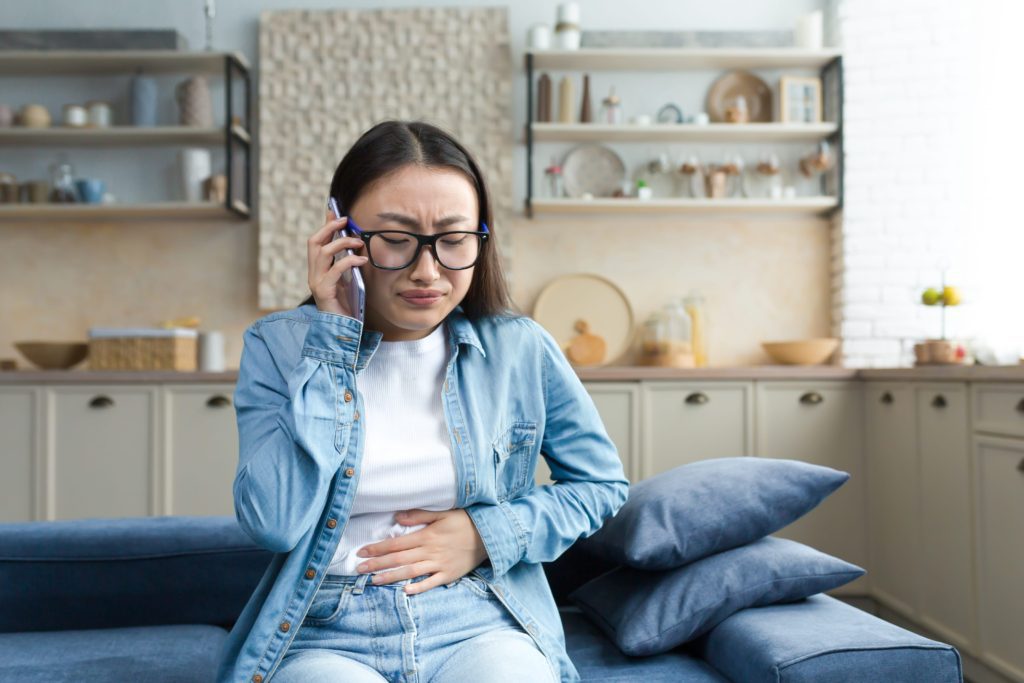 sick-asian-woman-at-home-woman-sitting-on-sofa