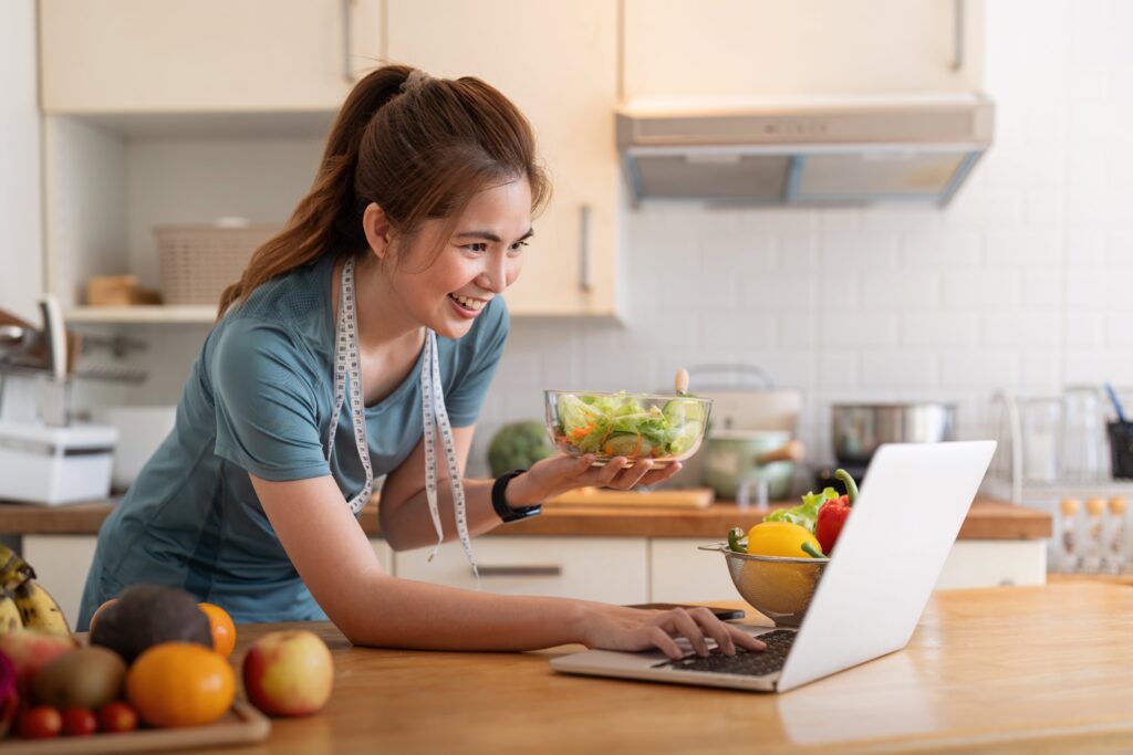 young-woman-eat-healthy-food-sitting-in-the-kitchen